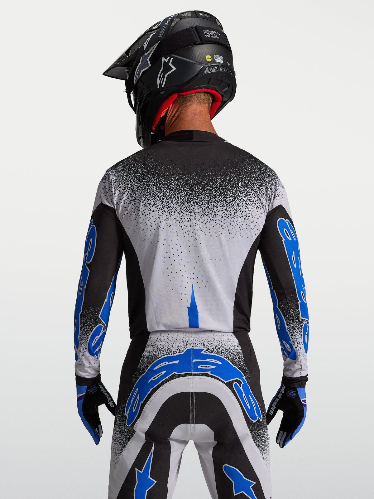 Alpinestars Supertech Hiten AFD trøje, motocrosstrøje til herre, sort og blå, set bagfra med atletisk pasform.