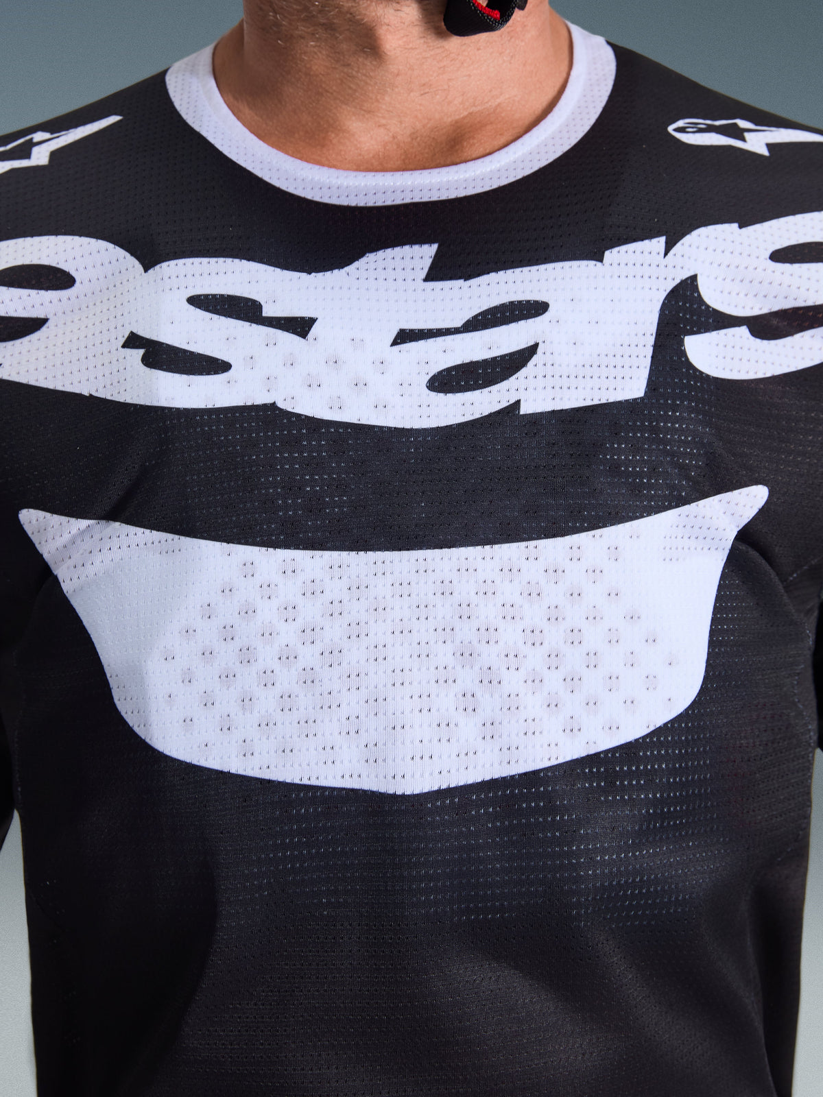 Alpinestars 2026 Racer Air Riway Jersey, Motocross Jersey, Black and White, close-up view of chest with large white logo, detailed mesh airflow fabric texture, technical breathable gear for off-road riding