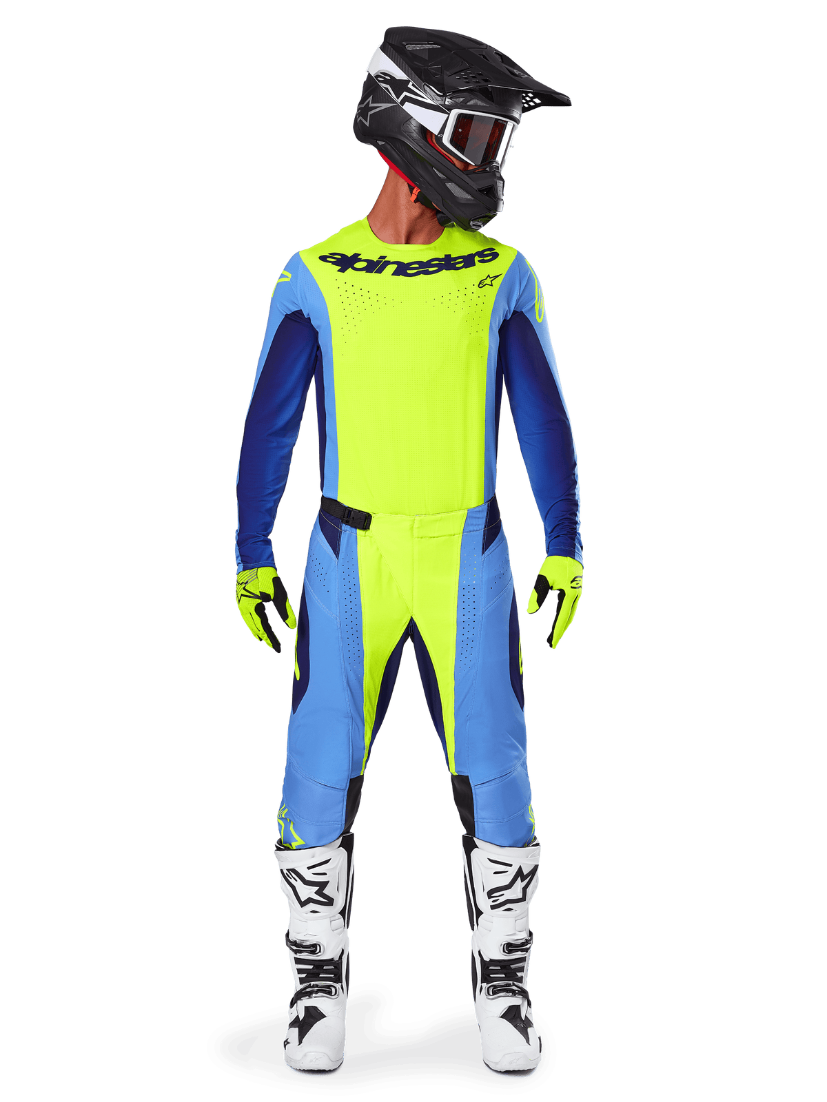 Motocross-kører i komplet racerudstyr, Alpinestars 2025 Techstar Melt Jersey i Gul Fluo og blå, matchende gule og blå motocross-bukser, sort hjelm med hvid grafik og goggles, hvide og sorte støvler, gule og sorte handsker, koordineret performance-outfit til terrænkørsel