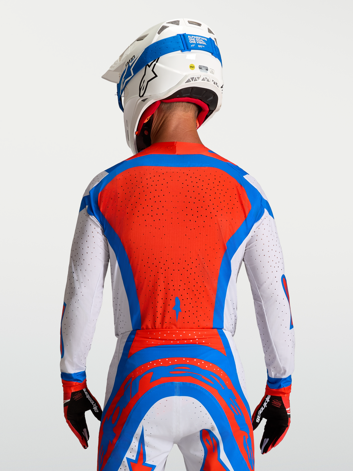 Alpinestars Supertech Vesta Jersey in red and white, featuring a ventilated mesh back for professional motocross racing.