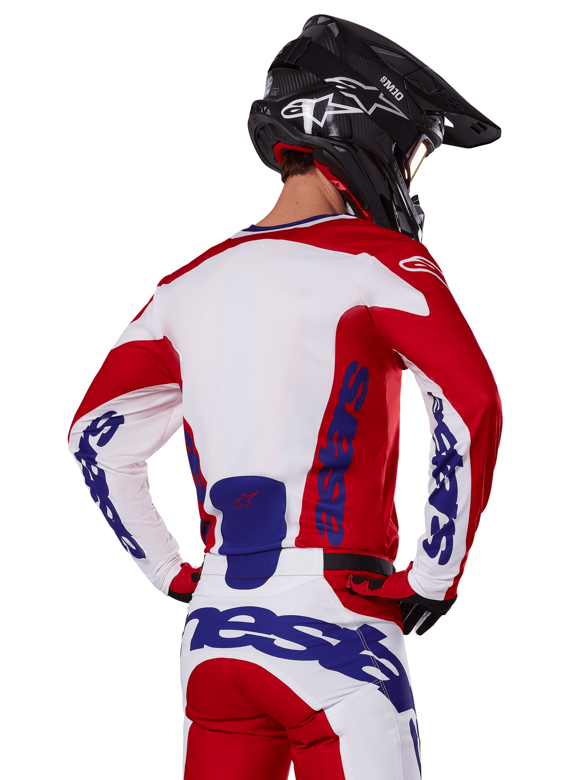 Alpinestars 2025 Racer Veil Jersey and Pants, Motocross Gear Set, Bright Red White and Blue, rear view of rider wearing matching gear and black motocross helmet, featuring bold blue Alpinestars branding, technical off-road racing apparel