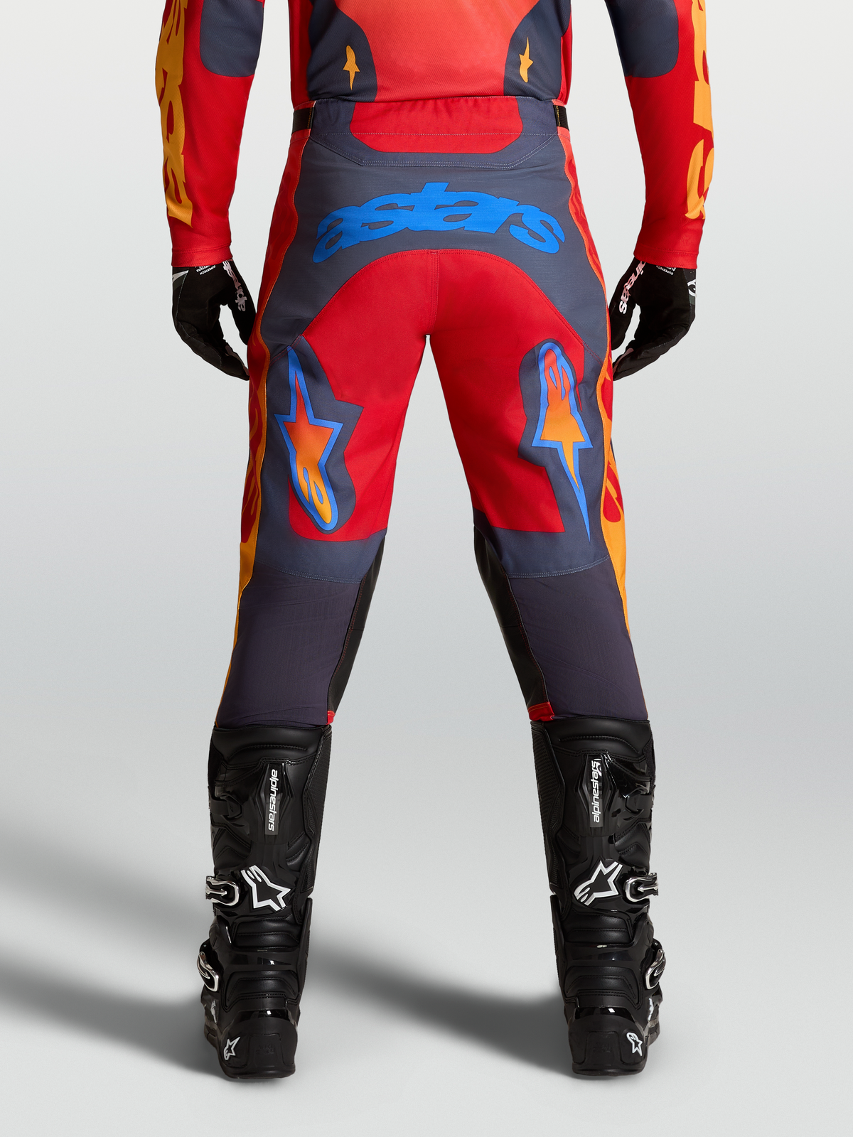 Alpinestars Racer Hunt Pants in Fire Red and Graystone, men’s motocross pants with pre-curved leg construction and blue Astars logo on seat.