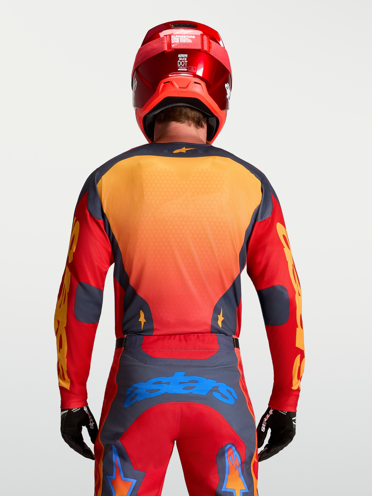 Alpinestars Racer Hunt Trøje, rød og grå motocross-trøje til herrer, set bagfra på model med gule og blå detaljer, svedtransporterende off-road gear