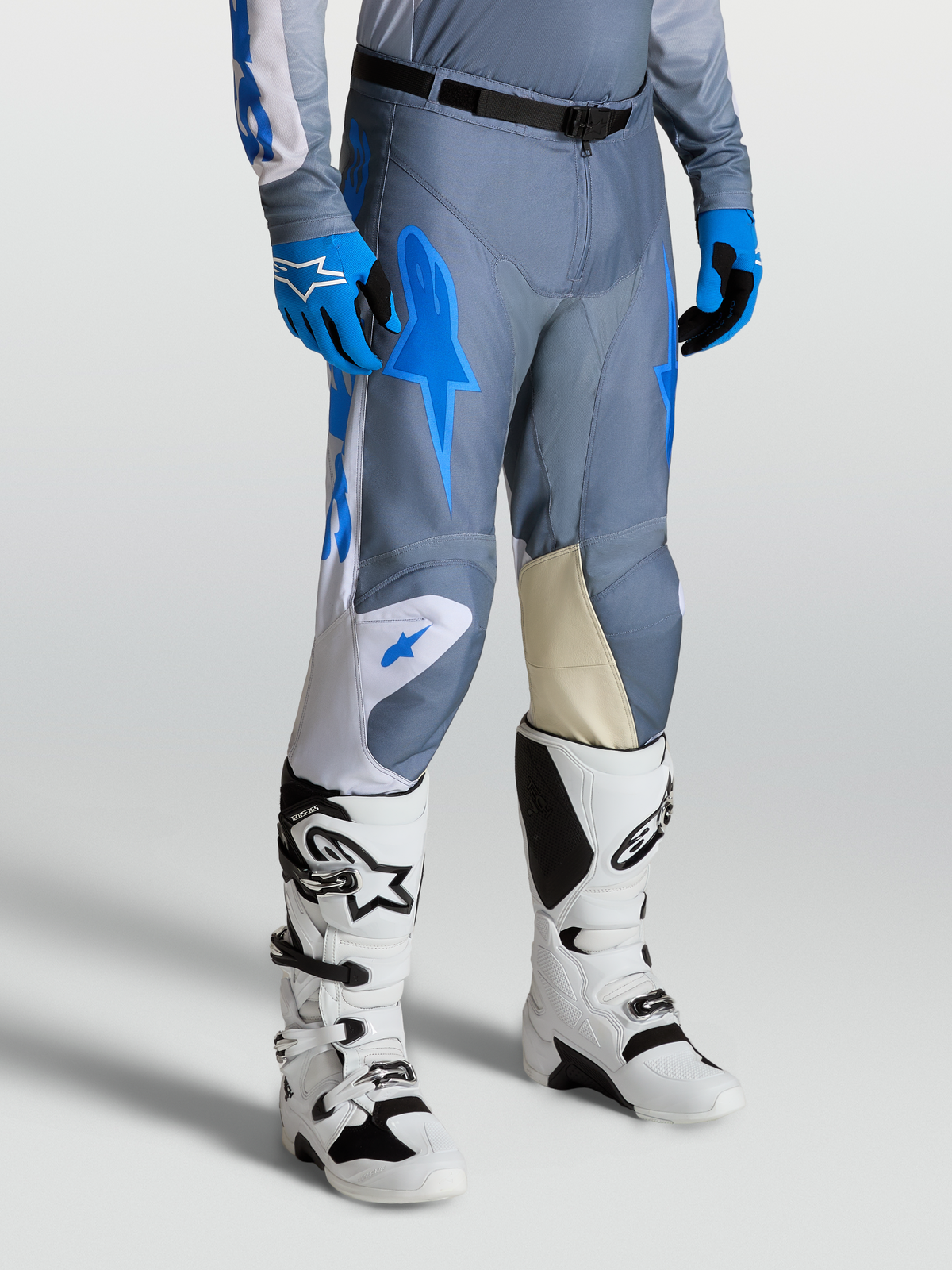 Alpinestars Racer Amber Pants, Men's Motocross Pants in Gray and UCLA Blue, with Goat Leather Knee Panels and White Techstar Boots.
