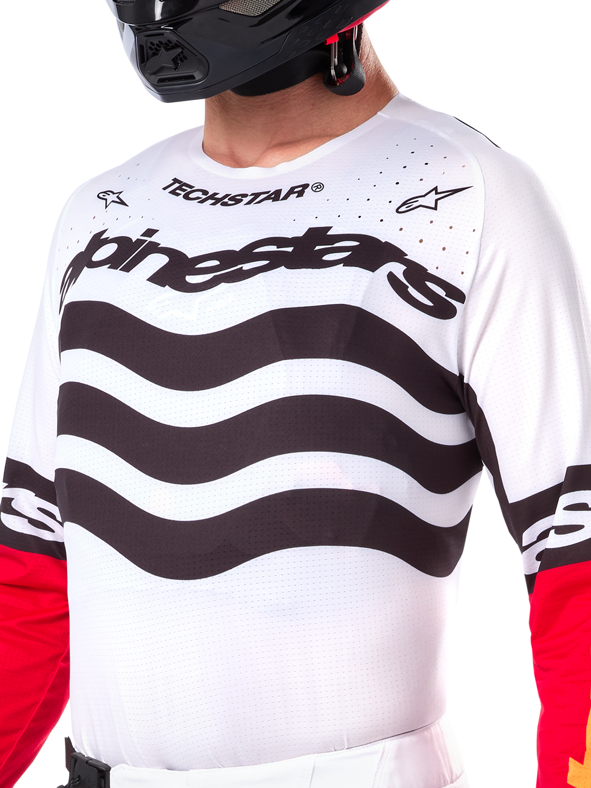 Alpinestars Limited Edition Techstar Deep Jersey, hvid motocross-trøje med bølgede sorte vandrette striber og røde ærmer, med Alpinestars- og Techstar-branding, små laserskårne perforeringer på det øverste af brystet for ventilation, atletisk off-road udstyr