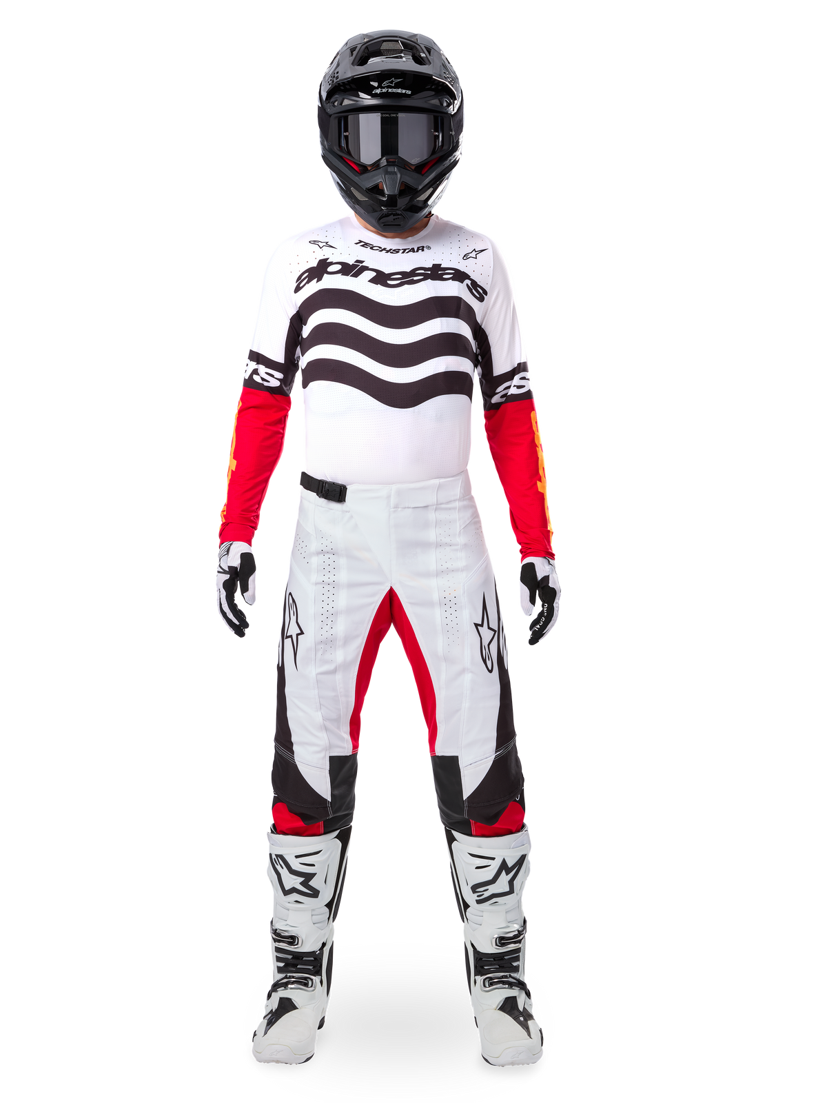 Motocrossrytter iført Alpinestars Limited Edition Techstar Deep Jersey i hvid, sort og rød med bølget grafik på brystet, kombineret med matchende hvide og røde bukser, en sort hjelm og hvide racerstøvler, komplet professionelt off-road udstyrssæt