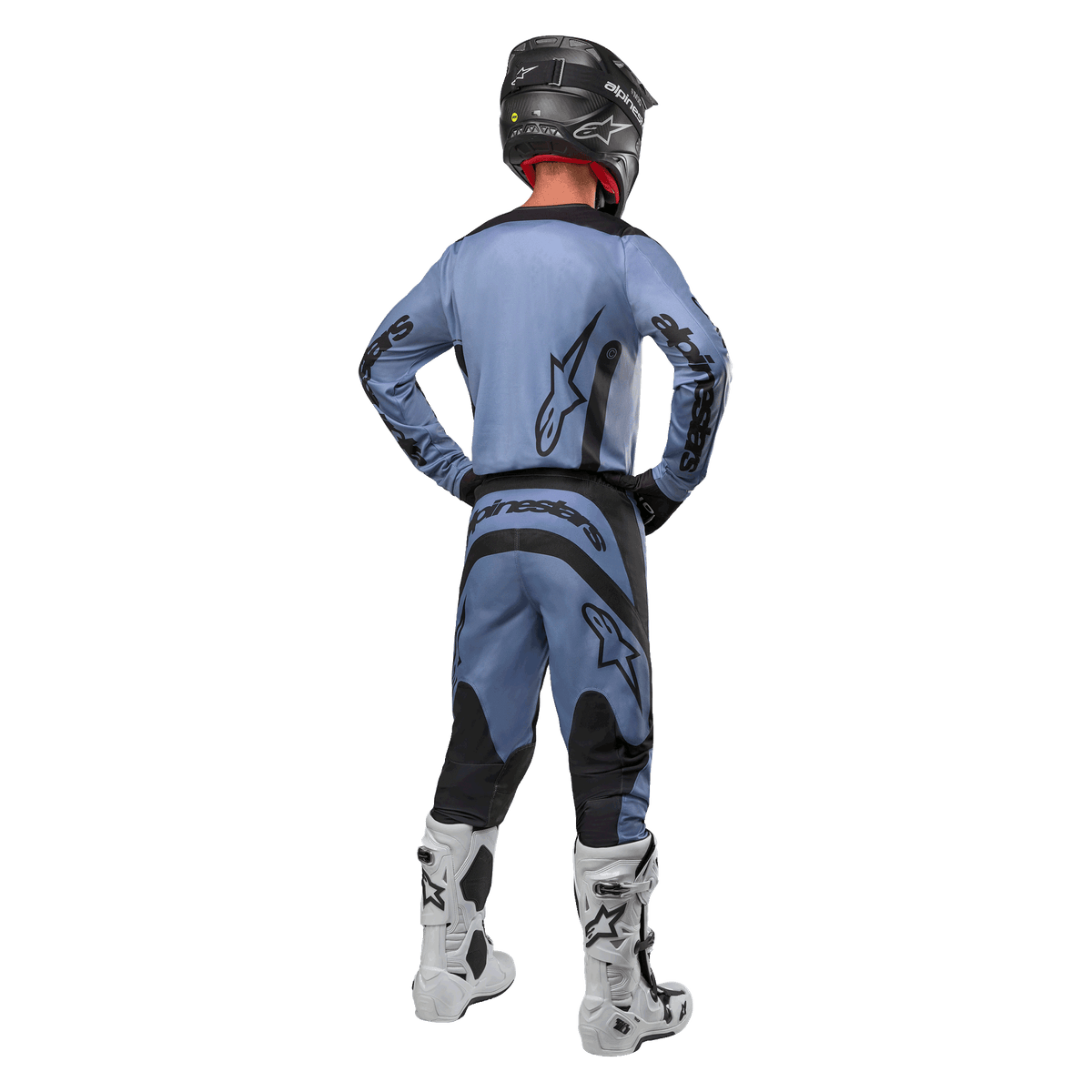 Motocross rider from behind wearing the Alpinestars 2024 Fluid Lurv Jersey and matching pants in Light Blue and Black, featuring black branding on the back and sleeves, paired with a black helmet and white boots.