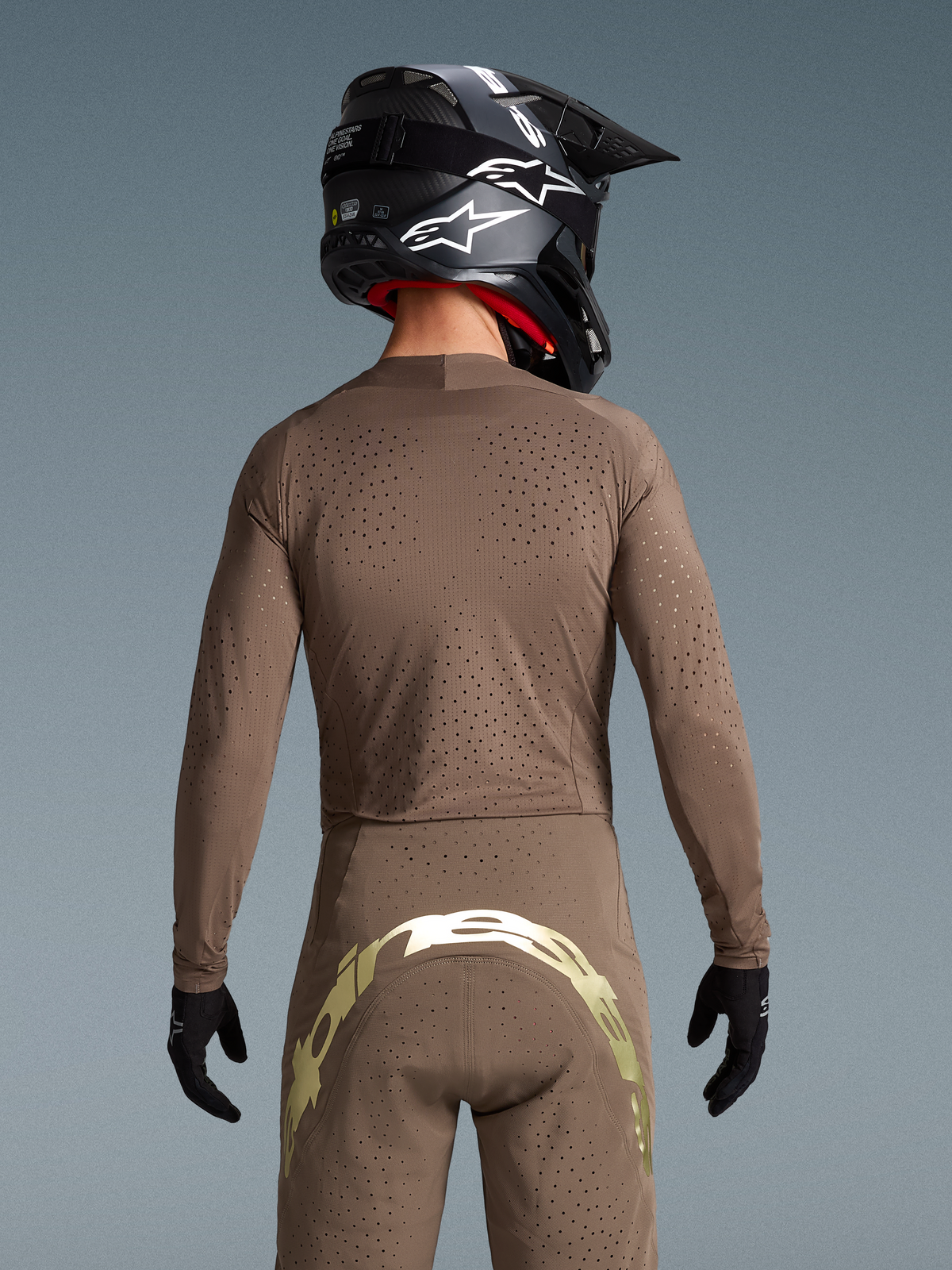Alpinestars Limited Edition Supertech Air Gold Jersey and MX pants in Earth Brown and Gold with laser-cut ventilation.