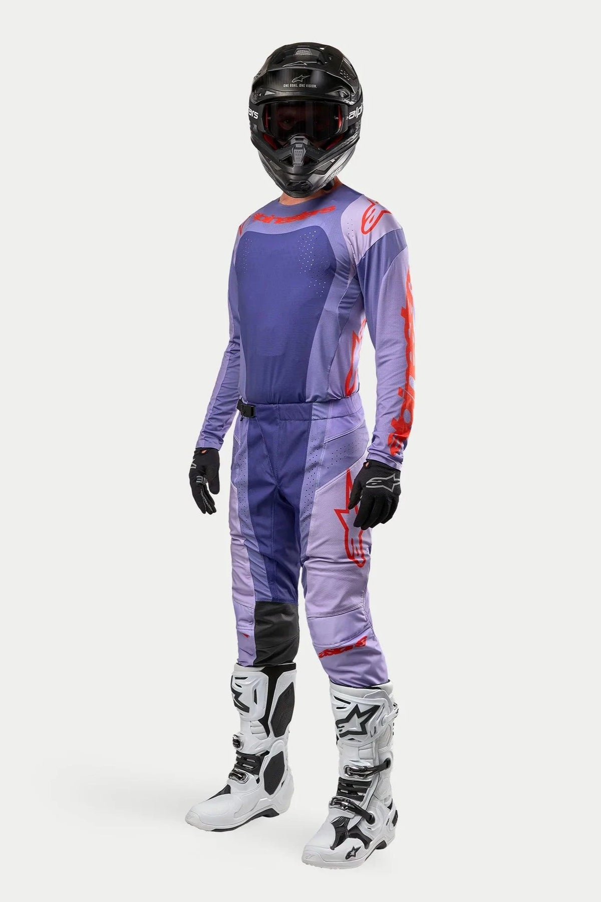 Motocross rider wearing the Alpinestars 2024 Techstar Ocuri Jersey in Purple Hot Orange, matching purple racing pants with orange accents, black helmet, white and black boots, and black gloves, complete off-road competition gear