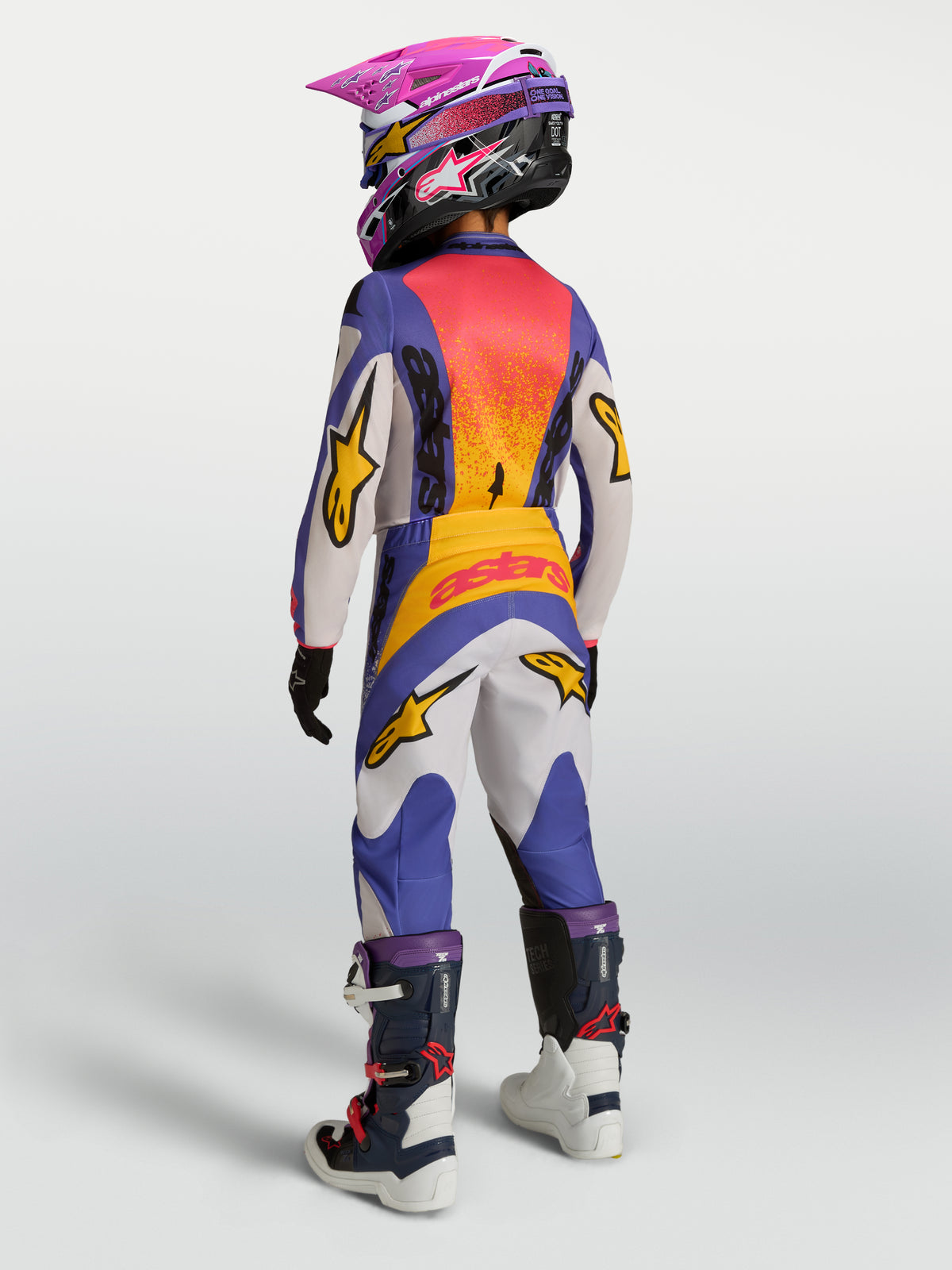 Alpinestars 2027 Fluid Drag trøje og udstyrssæt til ungdom, blåt og guld motocross-sæt med forlænget ryg.
