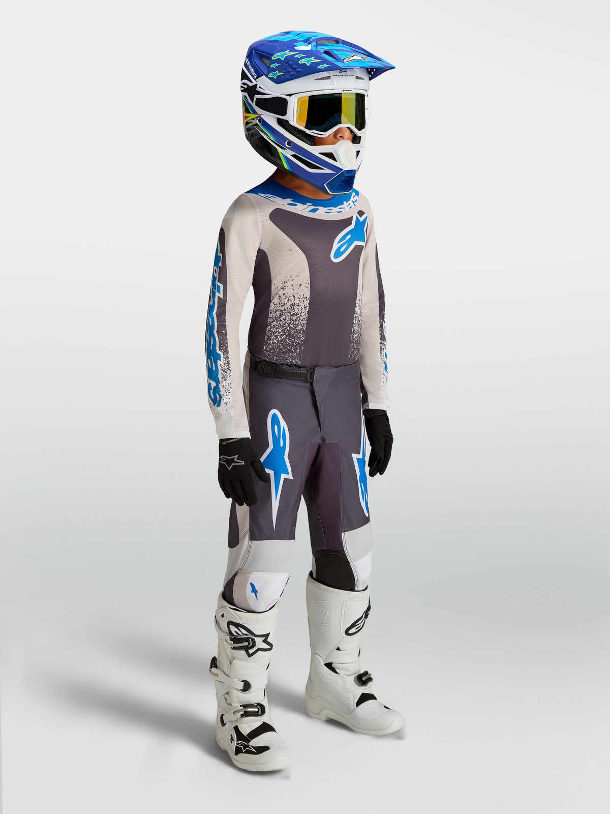 Alpinestars 2027 Youth Fluid Drag Jersey and Gear Set, Graystone and UCLA Blue youth motocross gear with white boots.