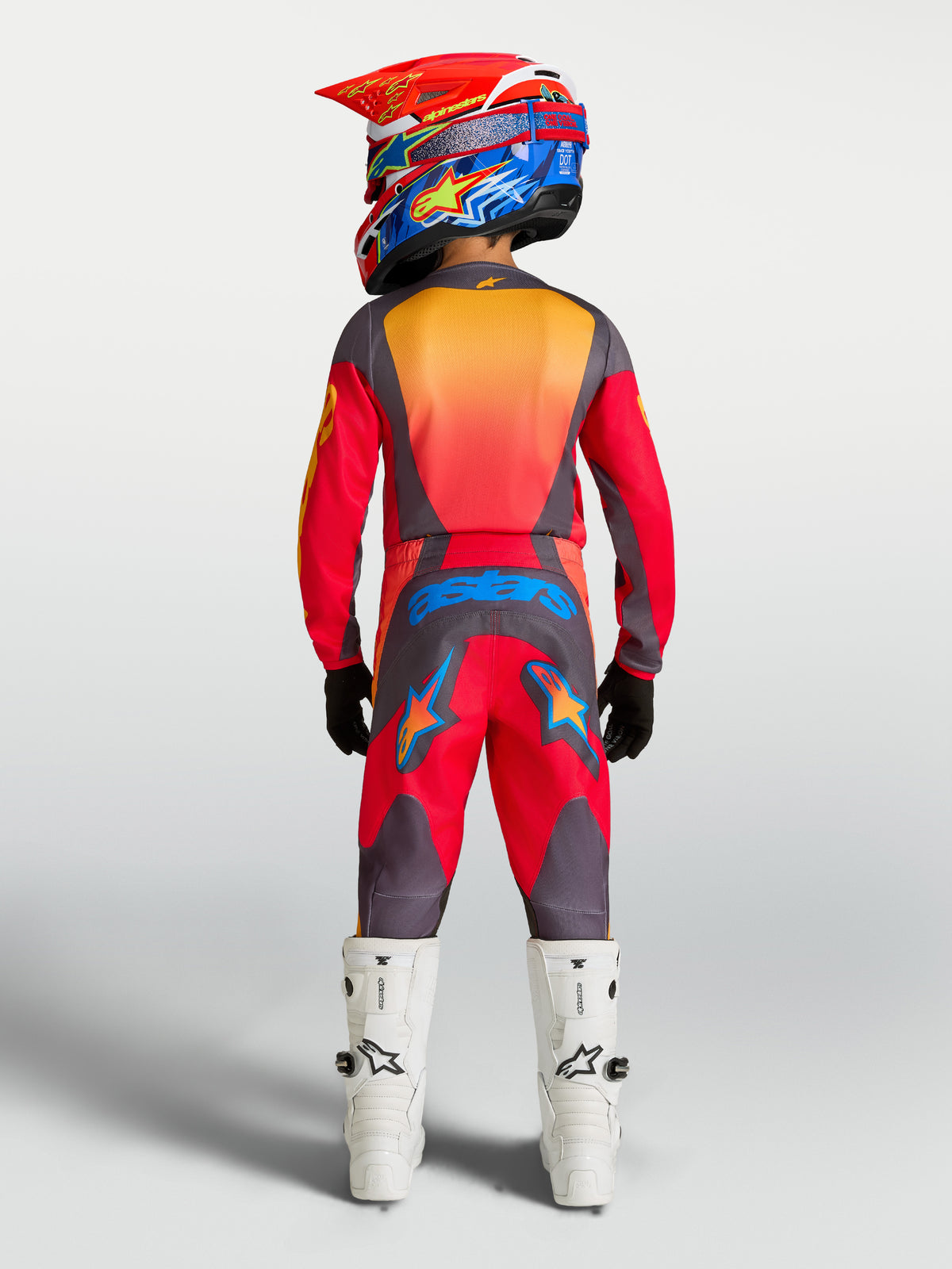 Alpinestars 2027 Youth Fluid Hunt Gear Set in Fire Red and Graystone, on-model rear view for youth motocross.