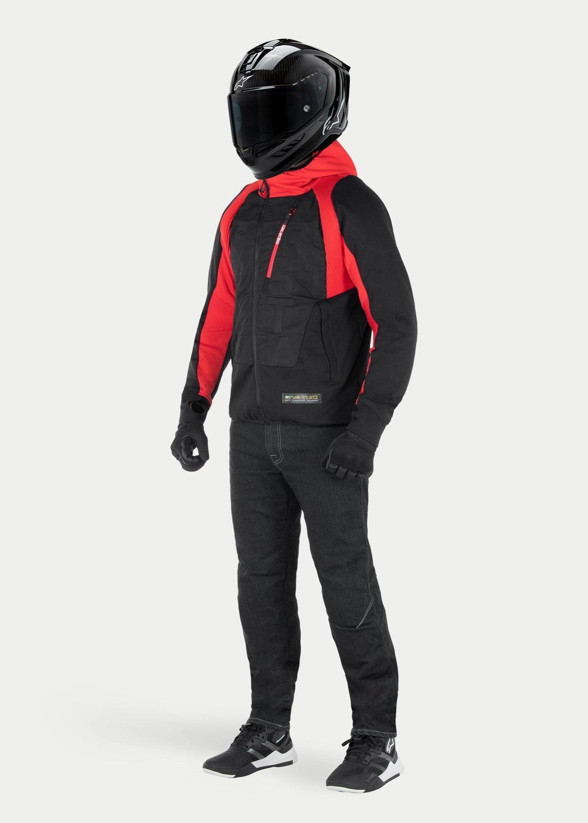 Alpinestars MO.ST.EQ Hybrid Hooded Jacket in Black Flame Red, urban motorcycle hoodie with red hood and shoulder accents, worn with black full-face helmet and riding pants, contemporary streetwear-inspired design