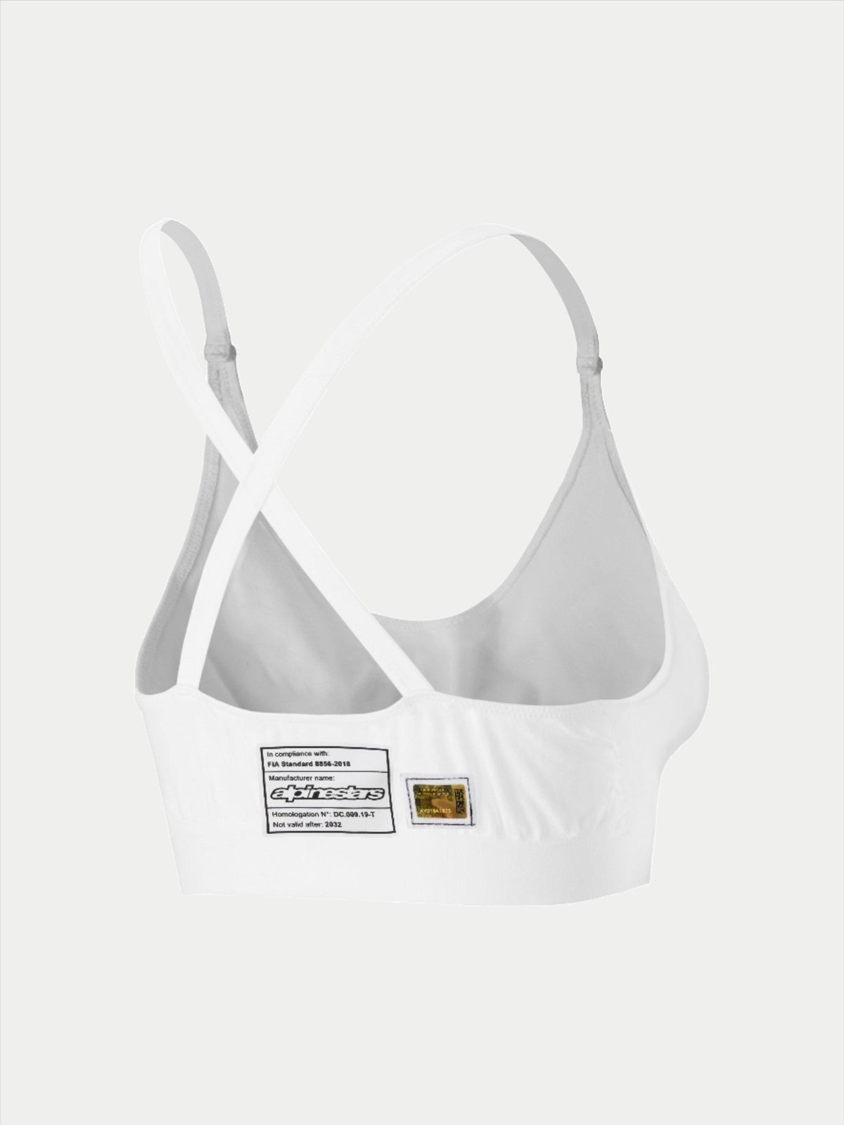 Alpinestars Stella TECH ZX Bra, white flame-resistant racing underwear, rear view showing cross-back strap design, features FIA 8856-2018 homologation label and hologram, lightweight performance base layer for women