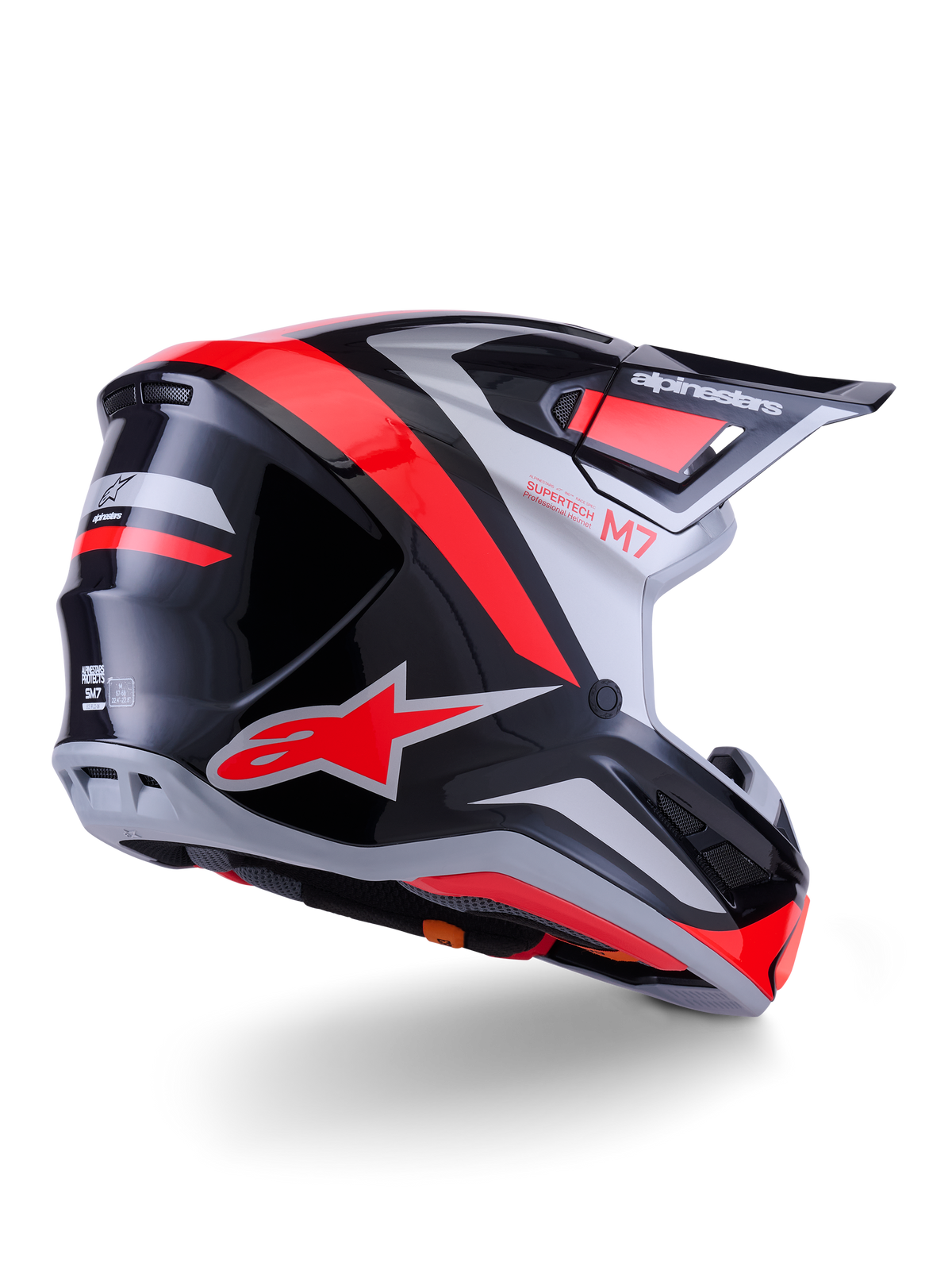Alpinestars S-M7 Rise hjelm, motocrosshjelm, sort, sølv og rød fluo glossy, trekvart visning bagfra, med iøjnefaldende rødt A-star-logo og sølvfarvede accenter, aerodynamisk skal med skygge, professionel off-road racingbeskyttelse