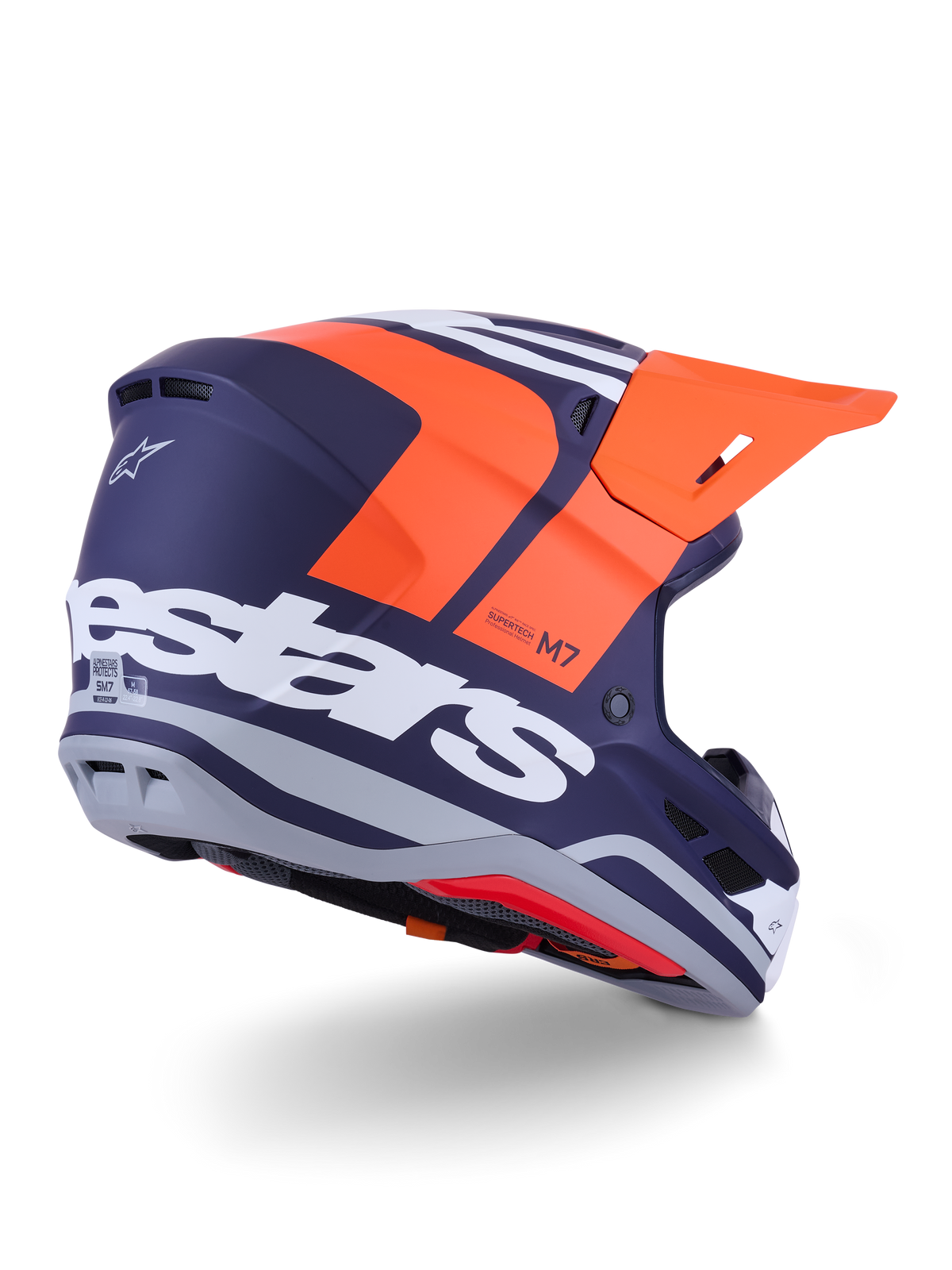 Alpinestars S-M7 Core hjelm, motocross-hjelm, mat orange og blå, set bagfra fra siden med markant hvidt Alpinestars-branding på bagsiden, stærk orange visir, aerodynamisk kompositskal med grå detaljer, professionel beskyttelse til off-road racing