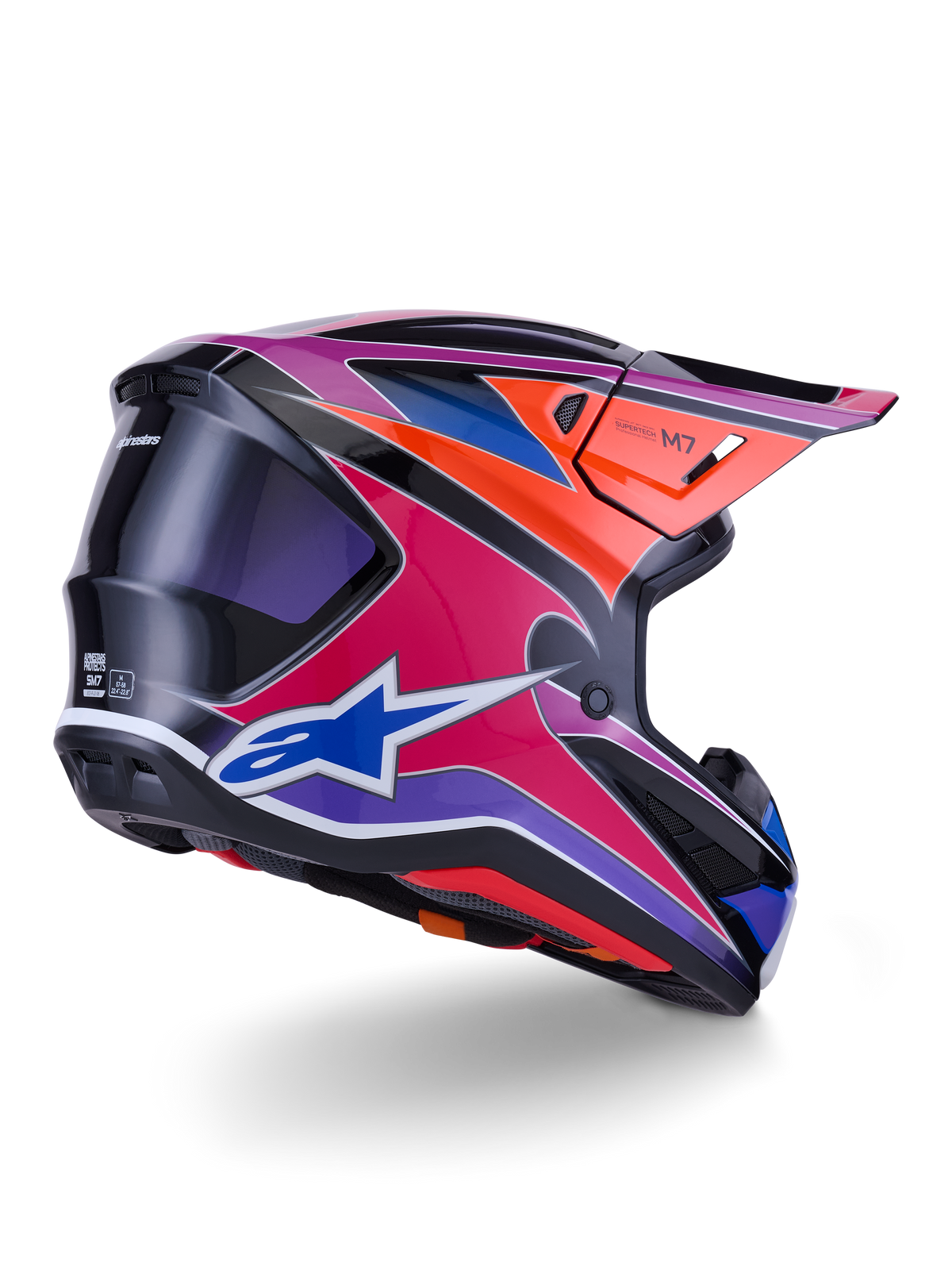 Alpinestars S-M7 Fuse hjelm, motocross-hjelm, blå, lilla og lyserød blank finish med orange og sorte detaljer, trekvart visning bagfra, der viser den aerodynamiske skal, visiret og ventilationsportene, professionel beskyttelse til off-road racing
