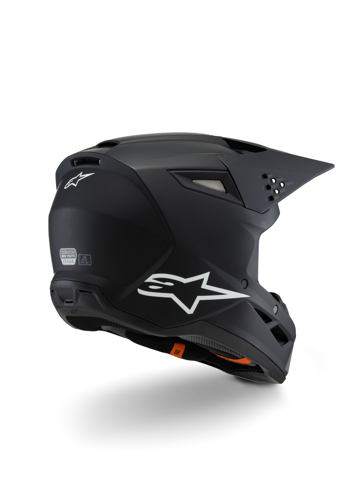 Alpinestars S-M3 Youth Solid hjelm ECE 22.06, motocrosshjelm, mat sort, set bagfra i trekvart profil med hvide Alpinestars-logoer, strømlinet skaldesign med integreret visir og ventilationsporte, off-road beskyttelsesudstyr til unge