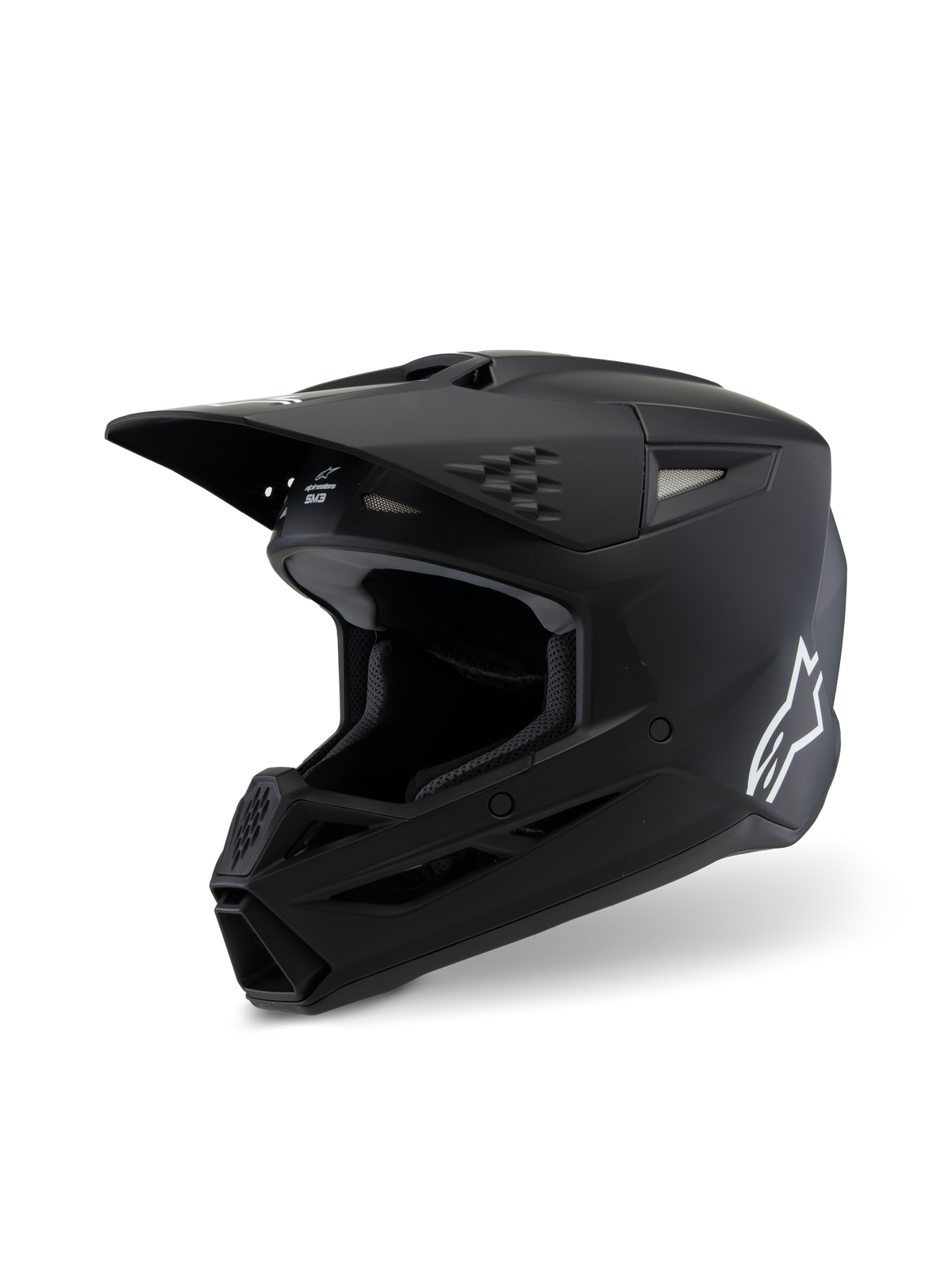 Alpinestars S-M3 Youth Solid hjelm ECE 22.06, motocross-hjelm, mat sort, sideprofil med hvidt Alpinestars-logo, aerodynamisk skal med ventilationsåbninger og integreret visir, professionel off-road hovedbeskyttelse til unge kørere