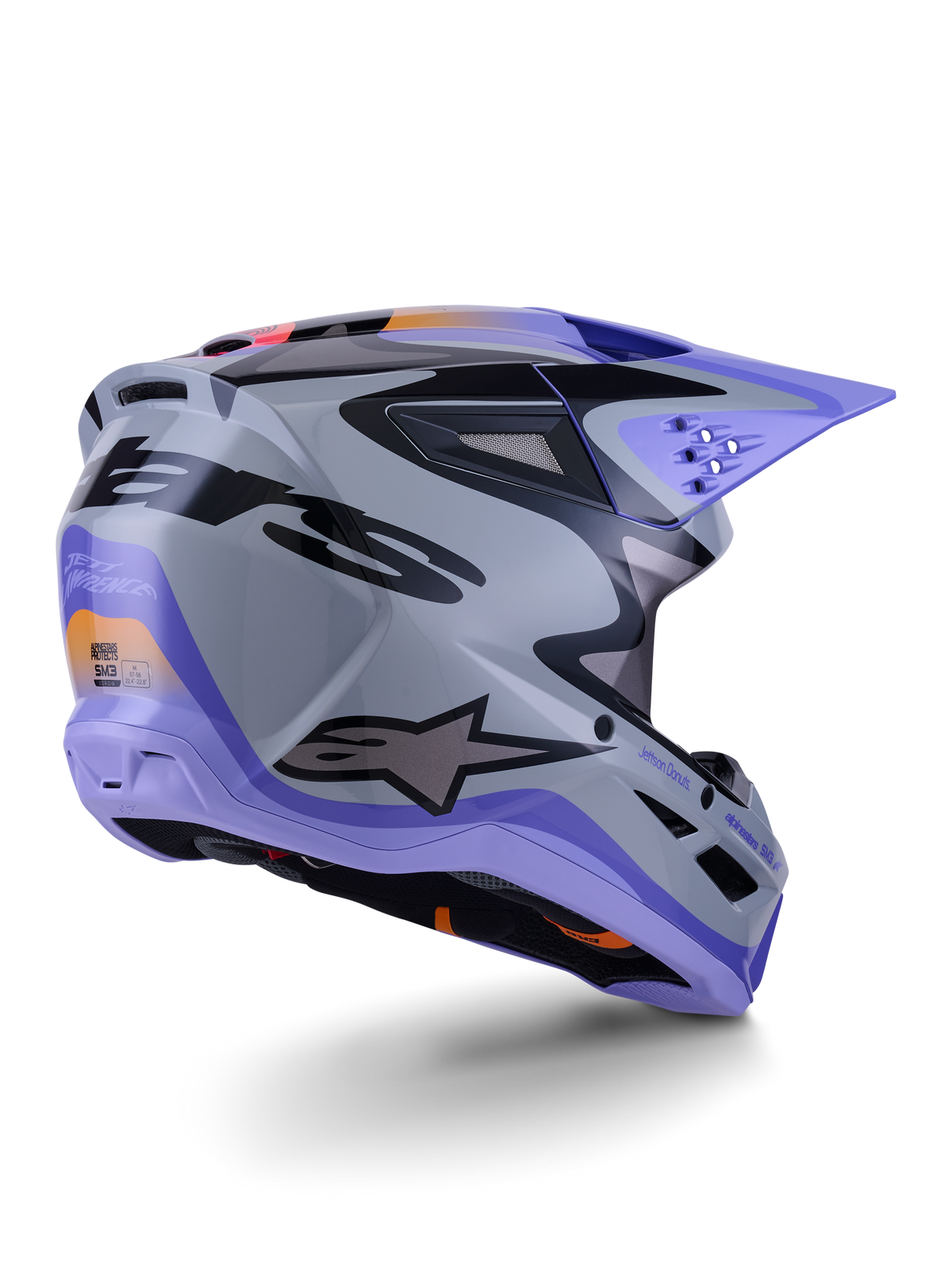 Alpinestars S-M3 Jettson hjelm ECE 22.06, motocross-hjelm, grå, lilla og sort blank, set bagfra i trekvart profil, der viser den aerodynamiske termo-injicerede skal med ventilationsåbninger og markant grafisk design