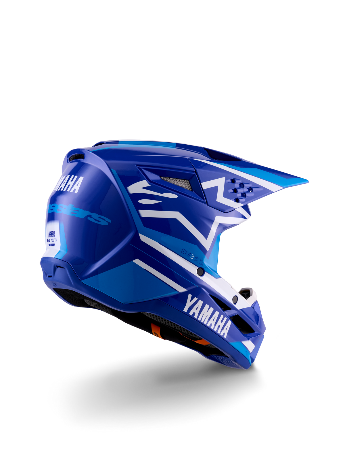 Alpinestars Yamaha S-M3 motocrosshjelm til unge, blå og hvid blank, med tydelig Yamaha-branding på siden og bagpå, aerodynamisk skaldesign med bagventilation, ungdomsspecifik hovedbeskyttelse til off-road, trekvart profil bagfra