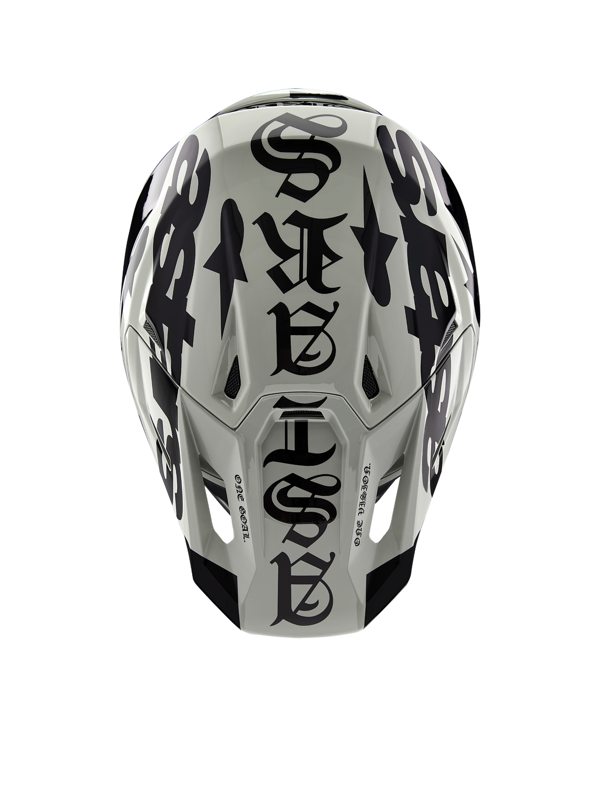 Alpinestars Limited Edition S-M7 Wolf Dust hjelm, set fra toppen, blank finish i Dune og sort, med markant typografi i gotisk stil hen over toppen og One Goal One Vision-detaljer, professionel hovedbeskyttelse til motocross-racing