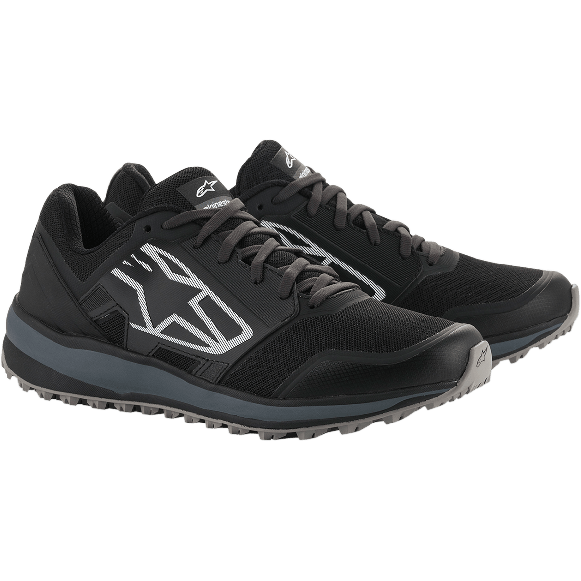 Alpinestars Meta Trail Shoes, performance running shoes, Black and Dark Gray, large white striped Astars logo on the side, lace-up design with a rugged gray sole, designed for all-day comfort in the paddock