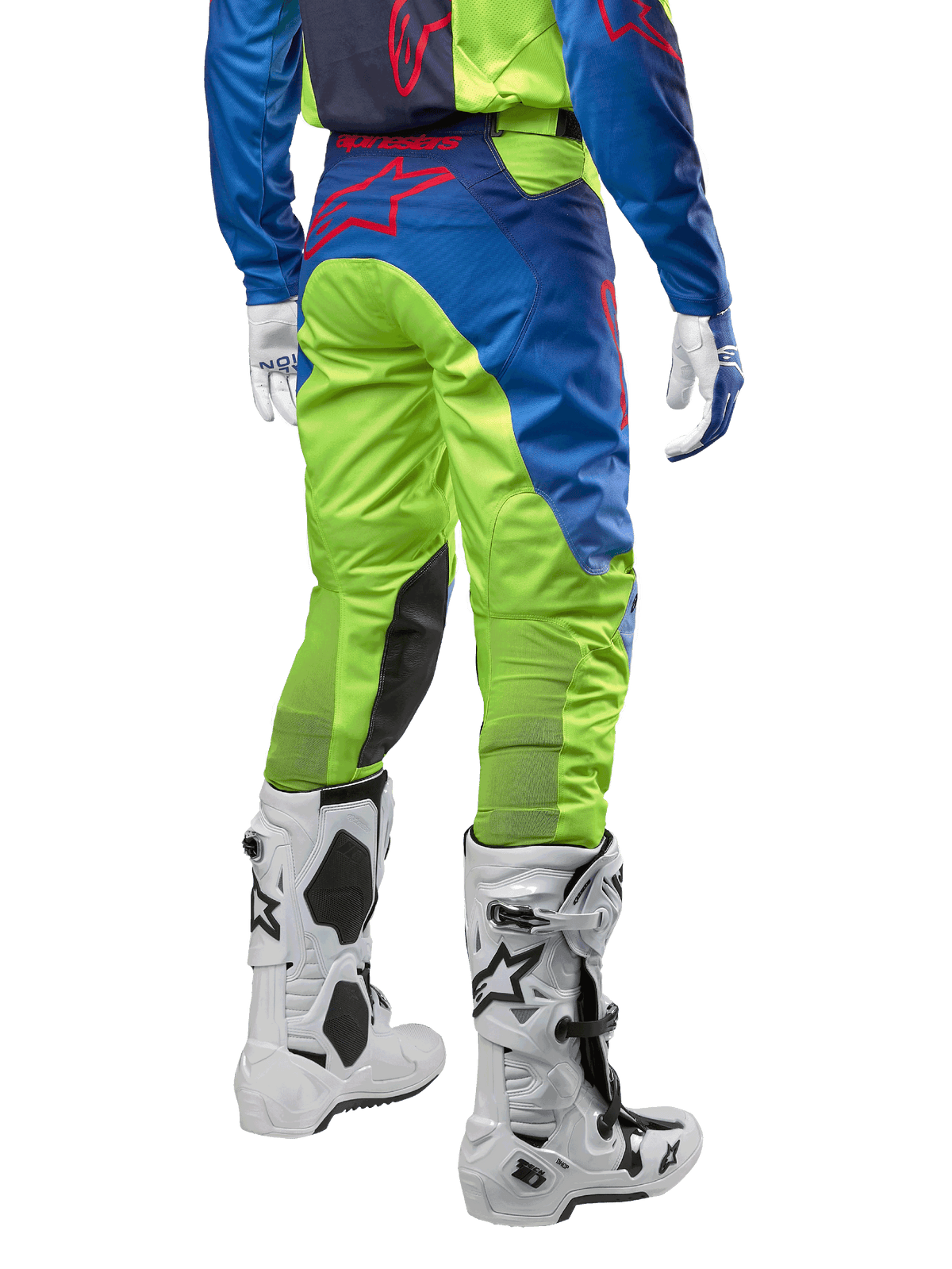 Alpinestars 2024 Racer Hoen bukser, motocross-bukser, neon-gul og mørkeblå, set bagfra, med rødt Alpinestars-logo, båret med matchende trøje, hvide handsker og hvide motocross-støvler, holdbart tekstil til off-road racing