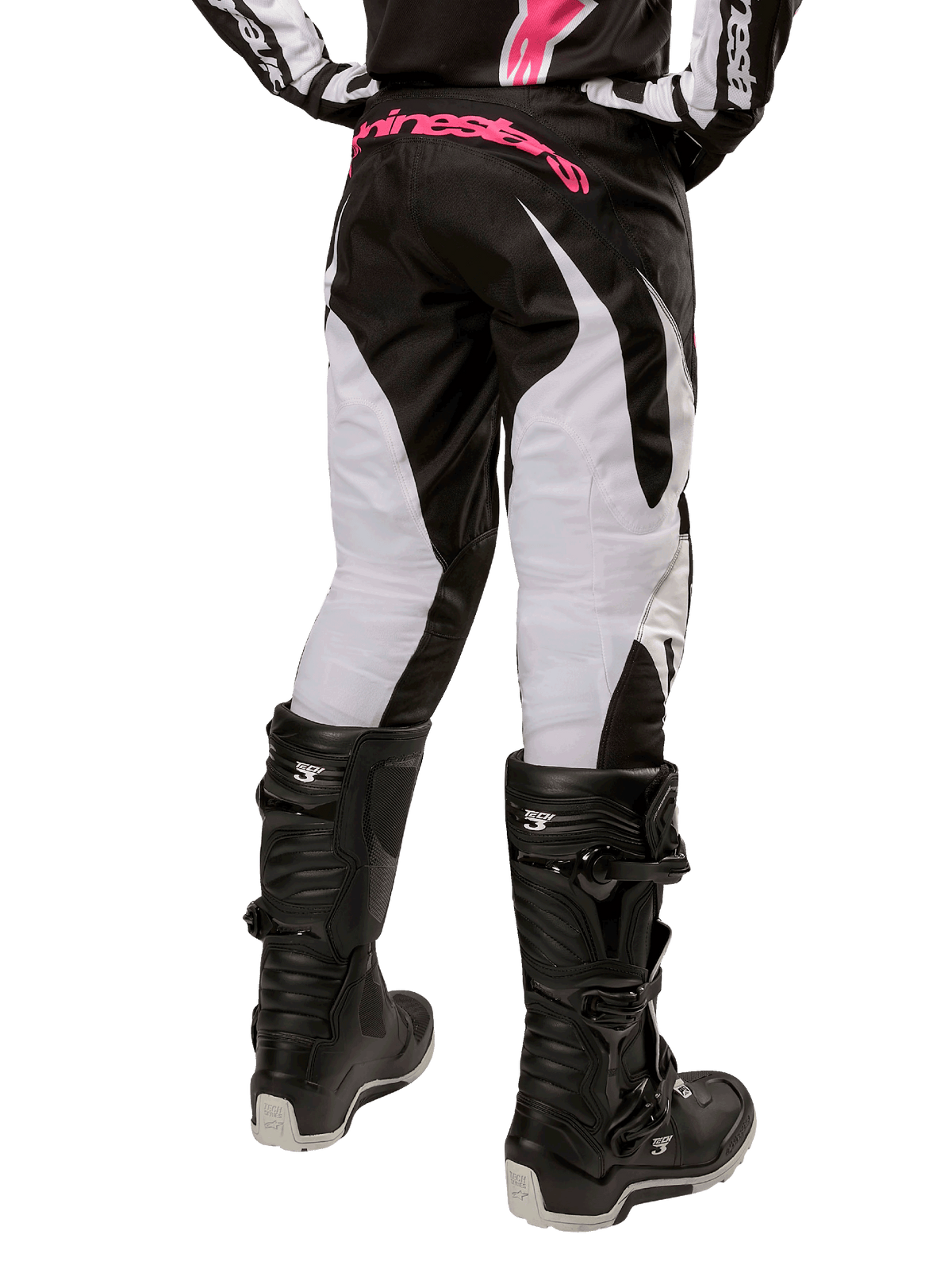 Alpinestars Stella 2024 Fluid bukser til kvinder, motocross-bukser, sort og hvid, set bagfra med hvide benpaneler og pink logo på linningen, båret med sorte Tech 3 støvler, holdbart udstyr til off-road racing