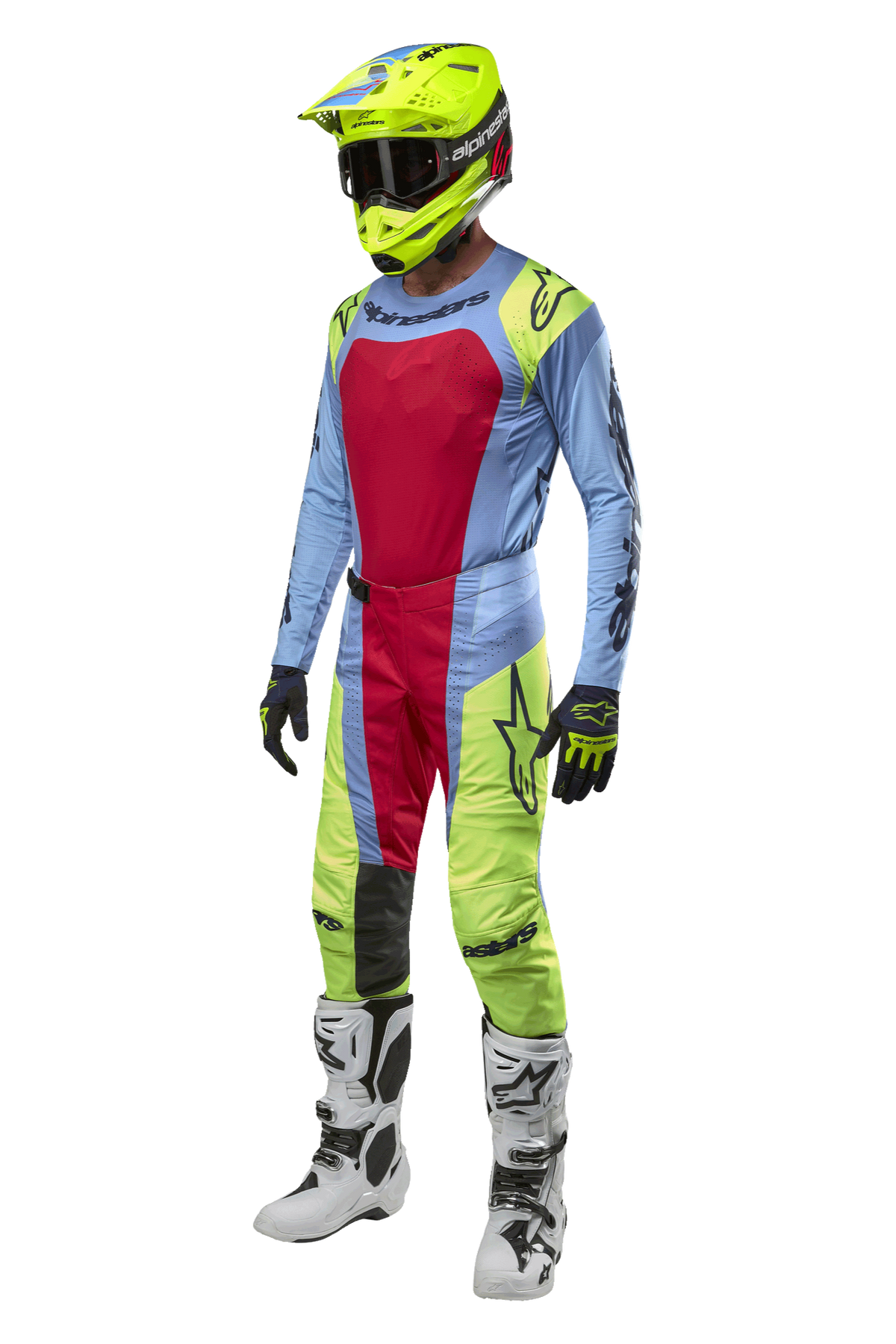 Motocrosskører iført Alpinestars 2024 Techstar Ocuri bukser i lyseblå, fluo gul og rød, koordineret racerudstyr inklusiv matchende jersey, fluo gul hjelm og hvide støvler, frontvisning af off-road konkurrence-outfit.