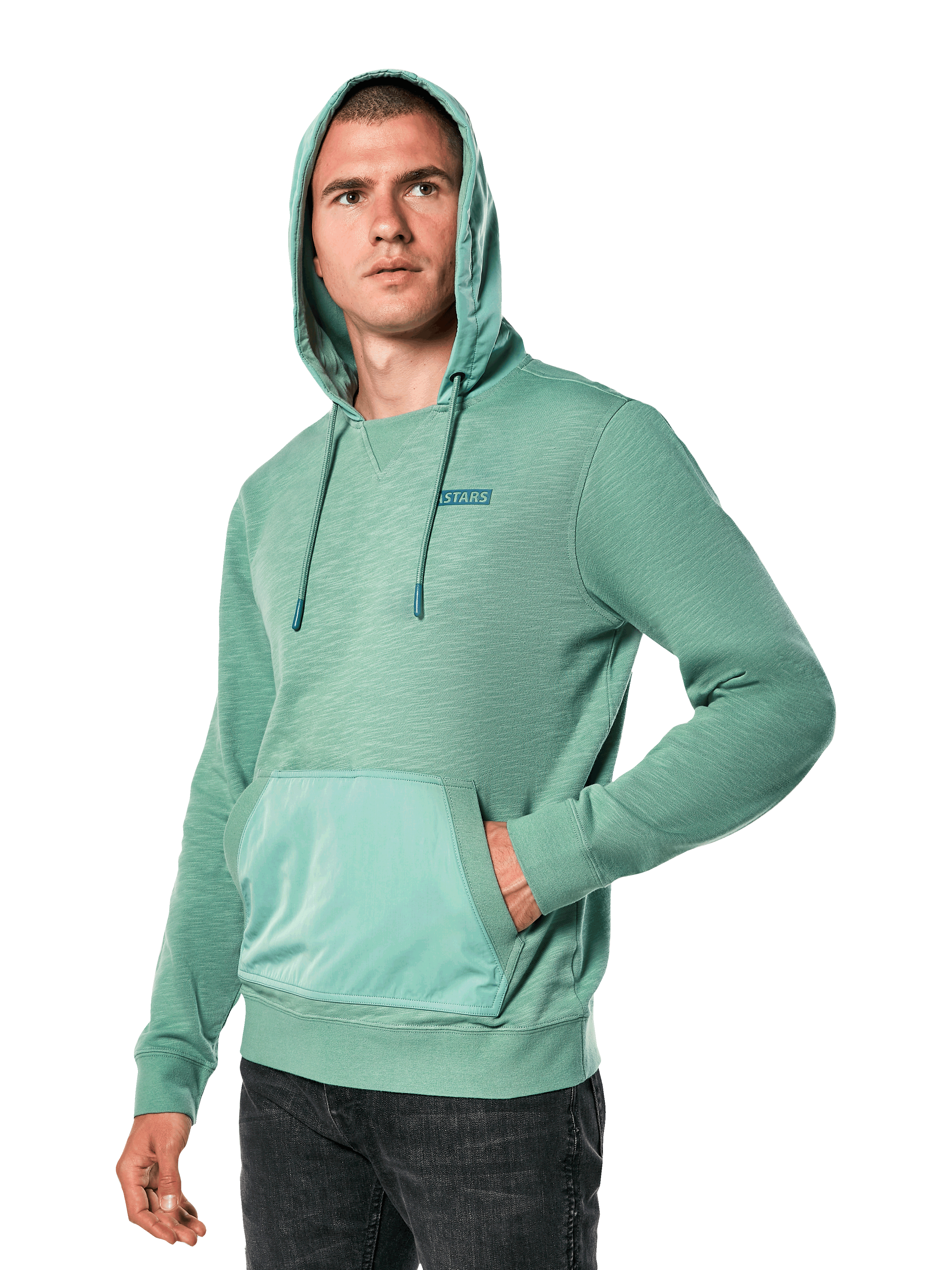Alpinestars Rooted Hoodie, Green slub French terry sweatshirt with overlay hood and kangaroo pocket, small STARS logo on chest, worn by a model with hood up and hand in pocket, casual motorsport-inspired streetwear
