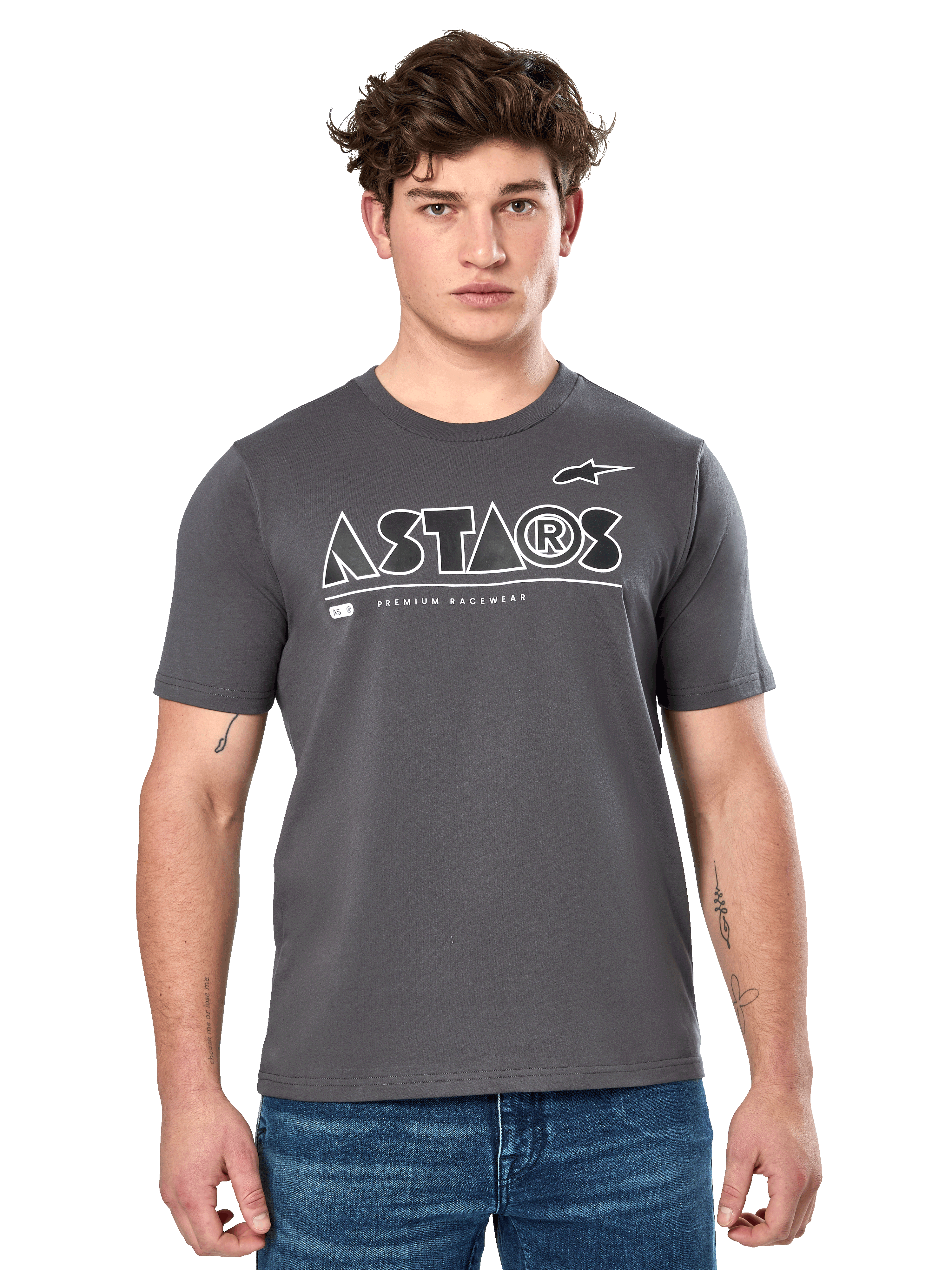 Alpinestars Cereal CSF Tee, Charcoal Gray Short Sleeve T-Shirt, worn by a male model with blue jeans, white ASTARS geometric logo and 'Premium Racewear' text, casual motorsport-inspired lifestyle apparel