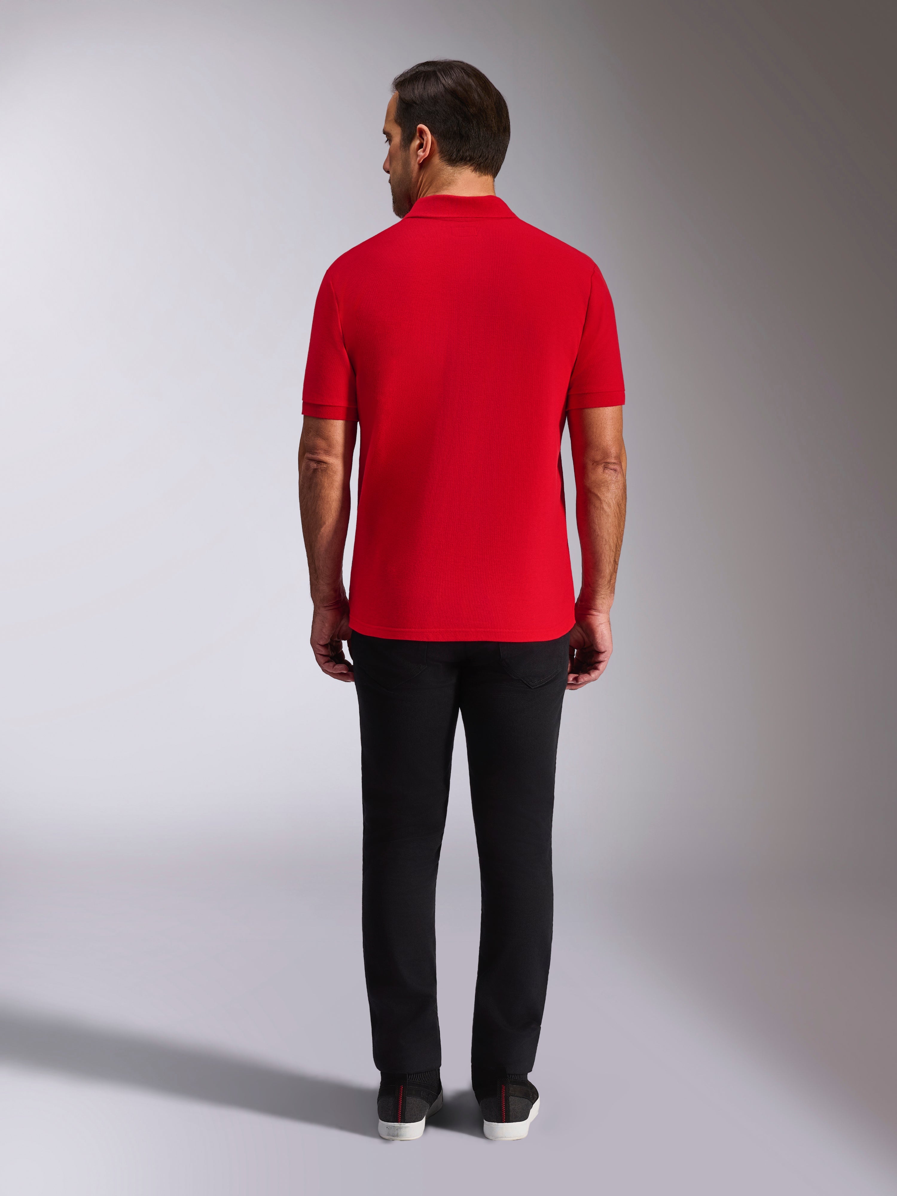 Alpinestars Endeavor Classic Polo, rød piqué-poloshirt, set bagfra, båret med sorte bukser, afslappet motorsport-streetwear med ribkrave og ribkanter på ærmerne