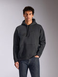 Alpinestars Emergent Oversized Hoodie, Black, male model wearing oversized pullover fleece hoodie, tonal 3D embroidered Astars logo, kangaroo pocket, drawstring hood, casual motorsport-inspired streetwear