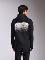 Alpinestars Obsessed hættetrøje, sort pullover-fleece set bagfra, med en stor hvid spættet MX-gradueringsgrafik på ryggen og røde Alpinestars ord-logoer på ærmerne, afslappet motorsport-inspireret streetwear