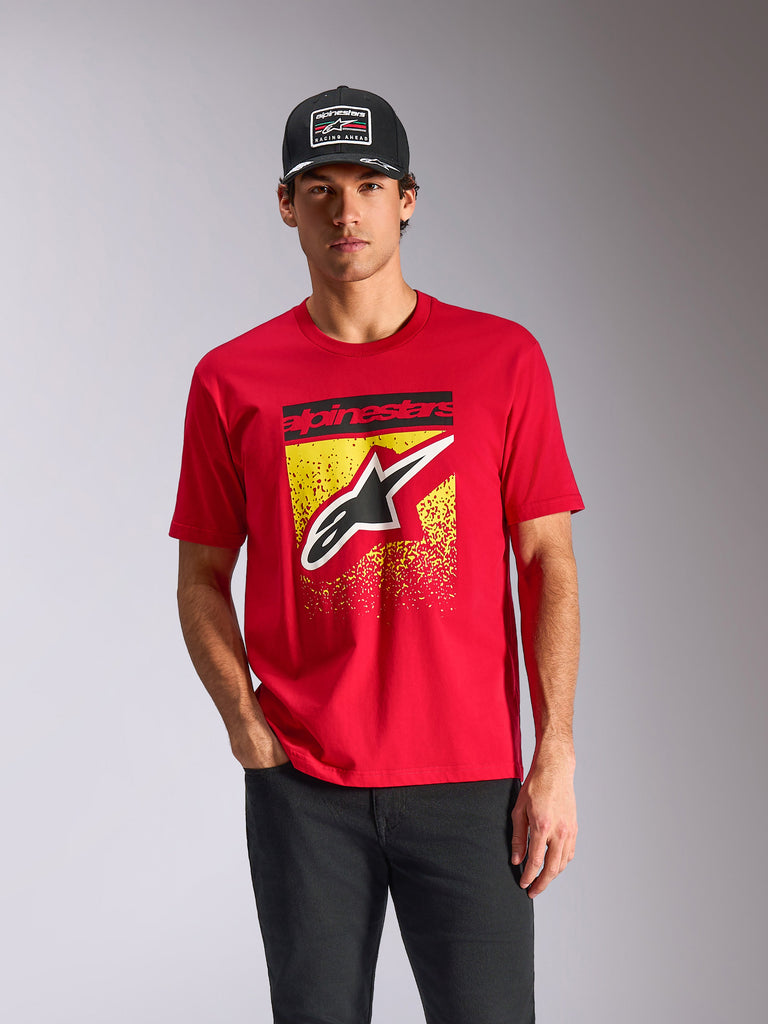 Alpinestars Noka CSF Tee, Short Sleeve T-Shirt, Red, Front Astars Logo with Yellow MX Gradation, worn by a male model with a black Alpinestars cap, casual motorsport streetwear