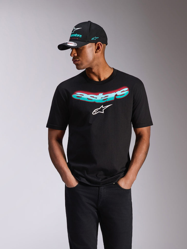 Alpinestars Ellipsoid CSF Tee, Short Sleeve T-Shirt, Black, teal and pink gradient Astars wordmark and white logo, worn by a model with matching Alpinestars cap and black jeans, casual motorsport streetwear