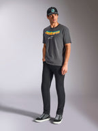 Alpinestars Ellipsoid CSF Tee, Short Sleeve T-Shirt, Charcoal Gray, featuring curved astars wordmark with color gradient and white logo, worn by model with black pants and cap, casual motorsport streetwear