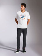 Alpinestars Plate CSF Tee, Short Sleeve T-Shirt, White, featuring a front Astars MX plate graphic with orange and blue accents, worn by a model with black pants and sneakers, Casual Motorsport Streetwear