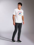 Alpinestars Plate CSF Tee, Short Sleeve T-Shirt, White, featuring a front Astars MX plate graphic in blue and orange, casual motorsport-inspired streetwear worn with dark pants and high-top sneakers