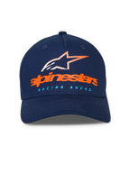 Alpinestars Instinct kasket, mørkeblå baseballkasket, buet skygge med struktureret krone, orange Alpinestars-navnetræk og stribet stjernelogo på fronten, lyseblå "RACING AHEAD" tekst, casual sportstøj