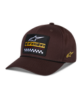 Alpinestars Matrix Snapback-kasket, brun, med broderet mærke på forsiden med hvidt logo, gul branding og ternet mønster, Astars-logo på siden, buet skygge, afslappet sportstøj