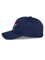 Alpinestars Trifecta Snapback kasket, marineblå, set fra siden, med buet skygge og trefarvet stribegrafik med hvid tekst, afslappet motorsport-hovedbeklædning