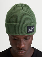 Alpinestars Unload Rib Cuff Beanie, winter sportswear knit hat, pea green, featuring a ribbed design and woven Alpinestars patch on the cuff worn by a model