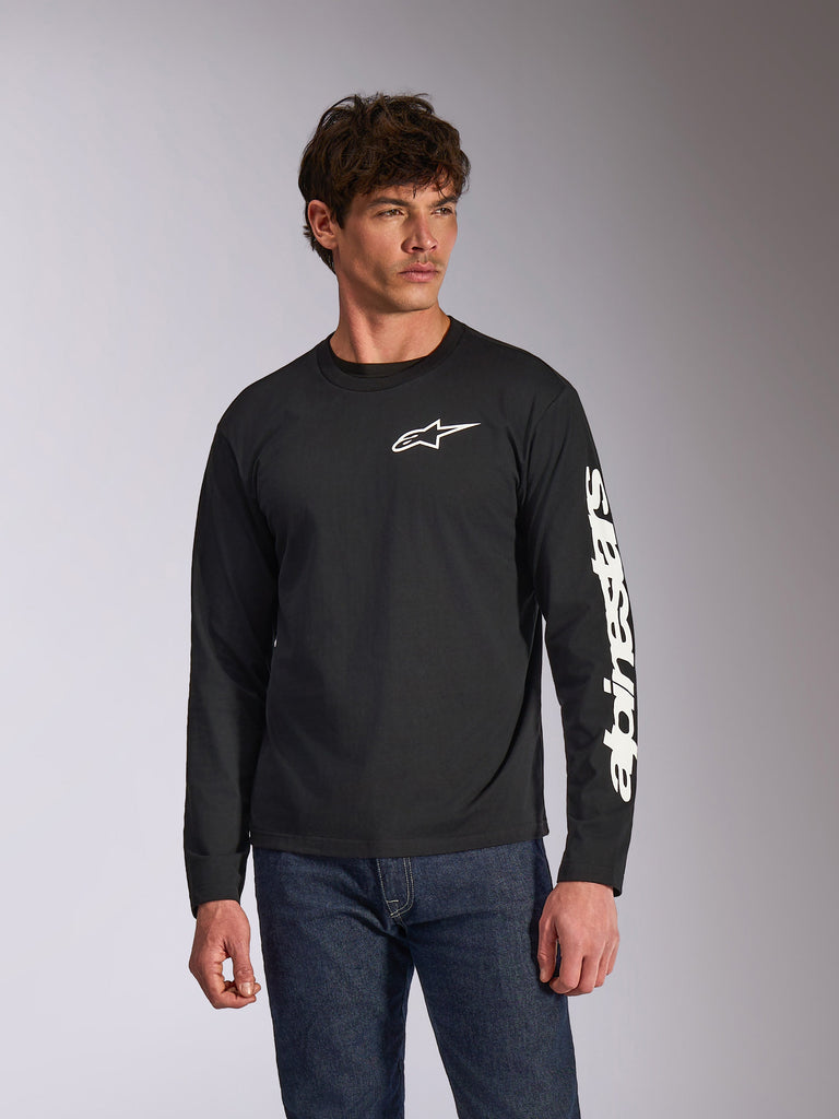 Alpinestars Trackside CSF langærmet T-shirt, sort, hvidt Alpinestars-logo på brystet og branding på ærmet, bæres af en model med blå jeans, afslappet motorsport-streetwear