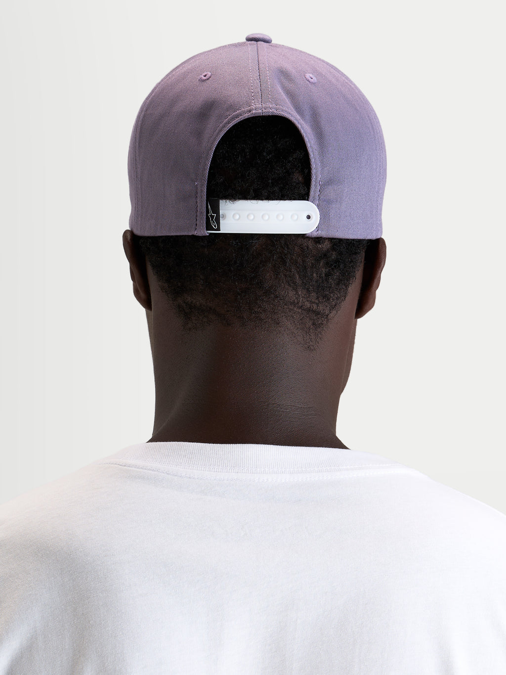 Alpinestars Ageless Snapback Hat, sportswear cap worn from the back showing the adjustable white snapback closure and structured dusty purple crown