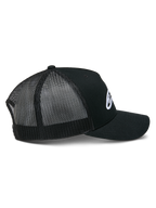Alpinestars Ageless Trucker Hat, Black, side view showing structured crown and white embroidered Astars logo, curved bill, and breathable black poly mesh back panels.