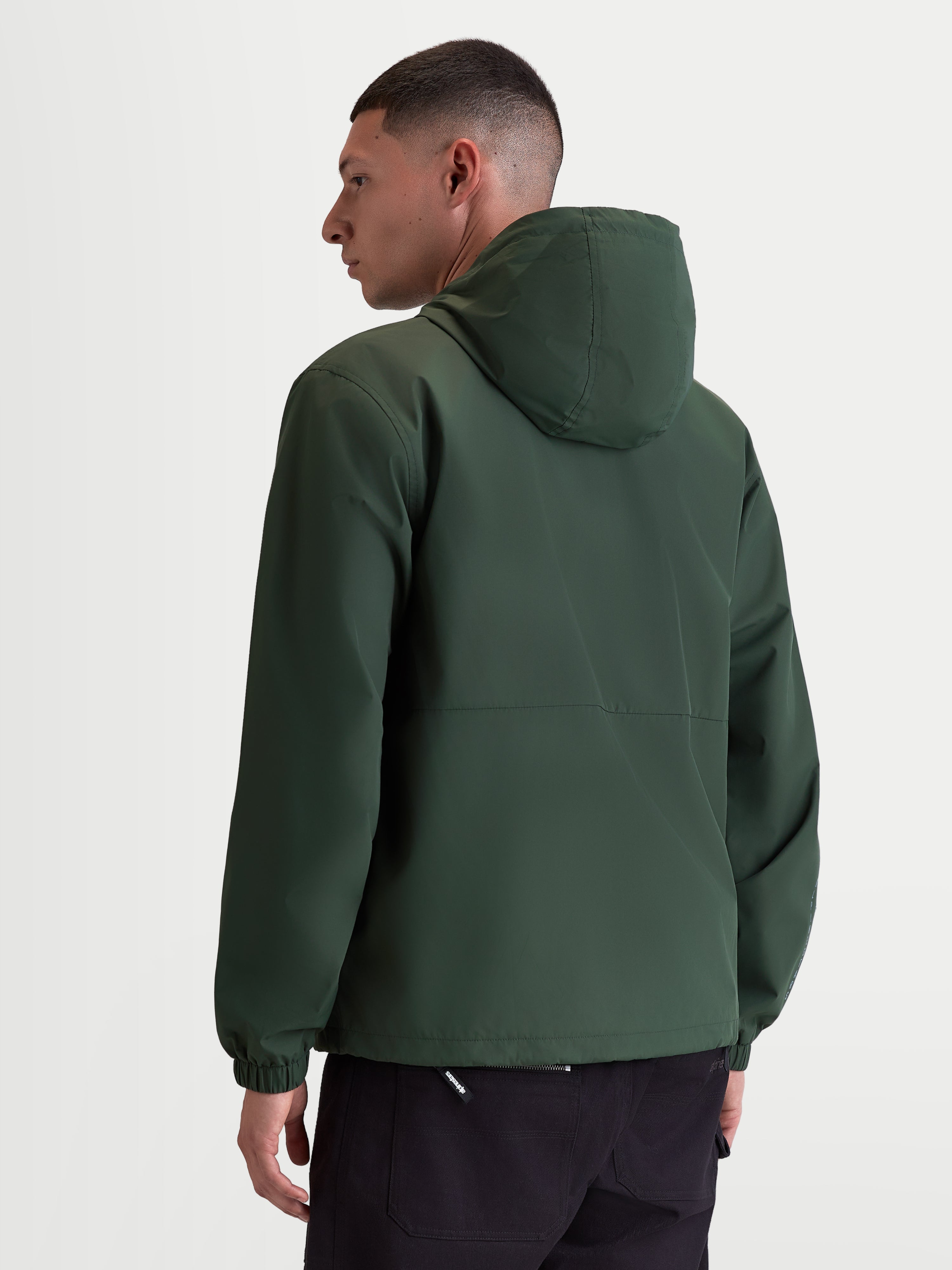 Alpinestars Speeder Resolve Windbreaker Jacket, Lightweight Sportswear Hooded Outerwear for Urban Use, Pine Green, Windproof 100% Polyester with Mesh Lining, Rear view on model highlighting the clean back design and elastic cuffs.