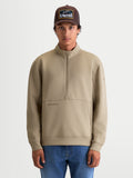 Alpinestars Apera Half-Zip Sweatshirt, beige herre-sweatshirt med halvlynlås og kængurulomme, afslappet motorsport-inspireret sportstøj, mand iført pullover i tri-blend fleece med tonalt logo