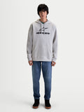 Alpinestars Prelude Oversized Hættetrøje, grå sportswear fleece-pullover med sort puff-print logo, afslappet oversized pasform, kængurulomme og hætte med snøre, båret af en model, fremstillet af bomuld og genanvendt polyester.